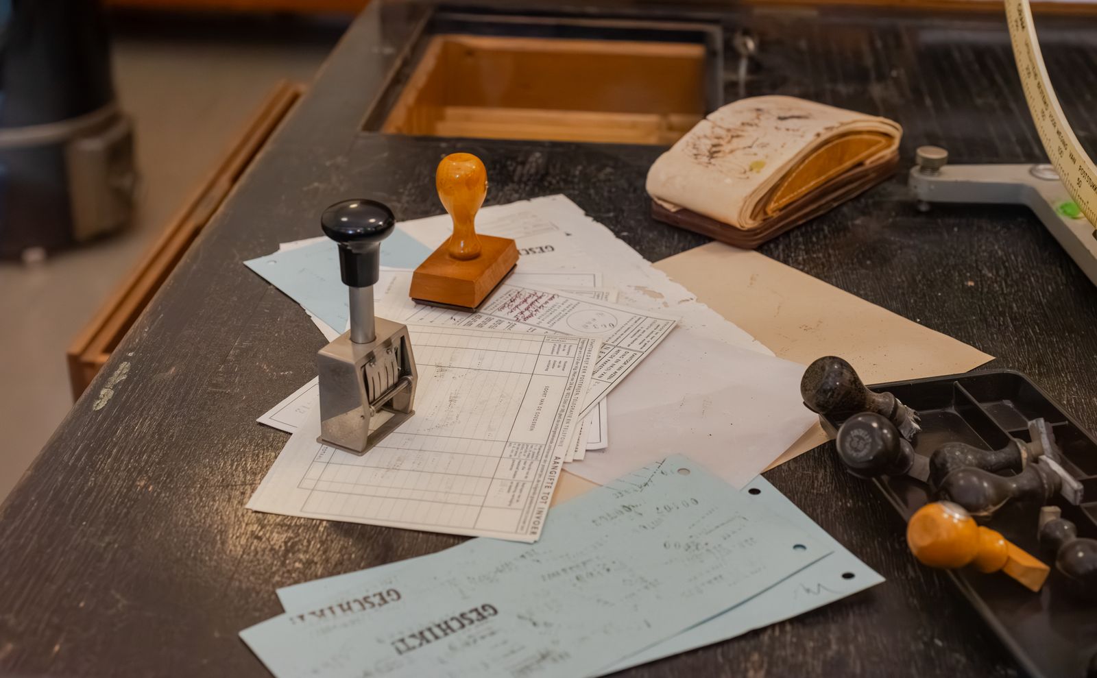 Documents and stamps on an office desk.